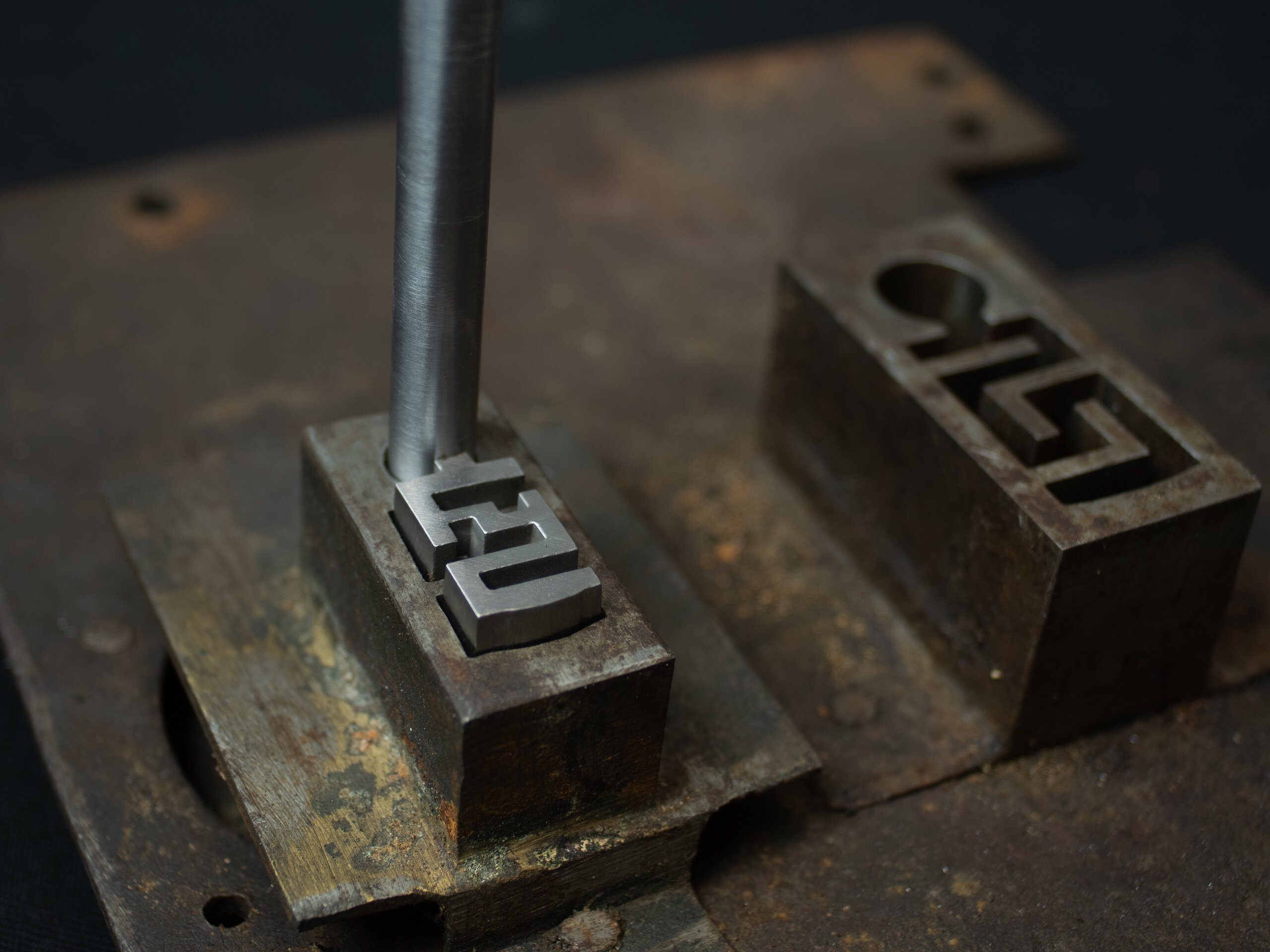 A key for a nineteenth-century French safe being worked on the bench