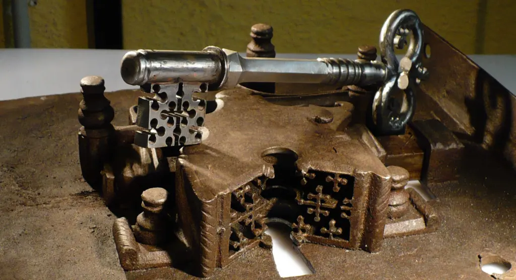 Key with a fretwork bit resting on a sixteenth-century strongbox lock