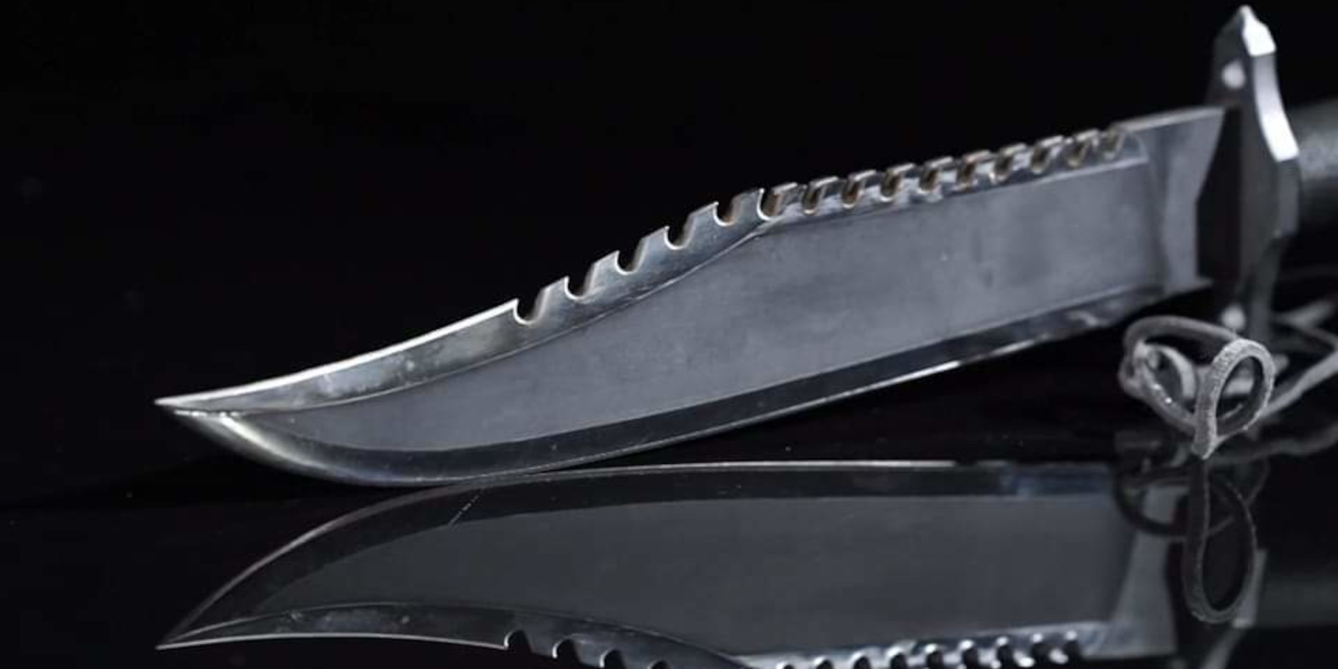 The blade of an original Jimmy Lile Mission, number 3 of 10, photographed on a black background