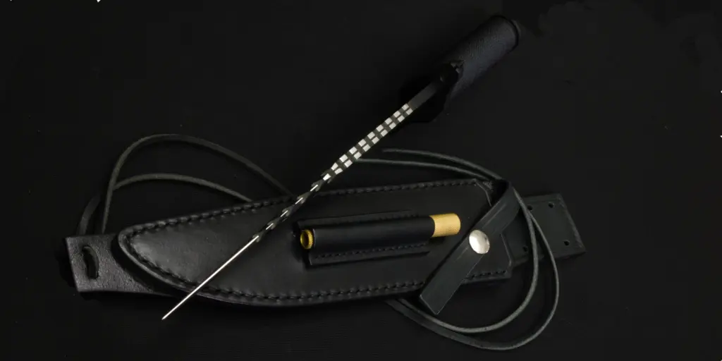The leather sheath of the Mission with the cord wound round it and the brass-capped sharpener in its pocket