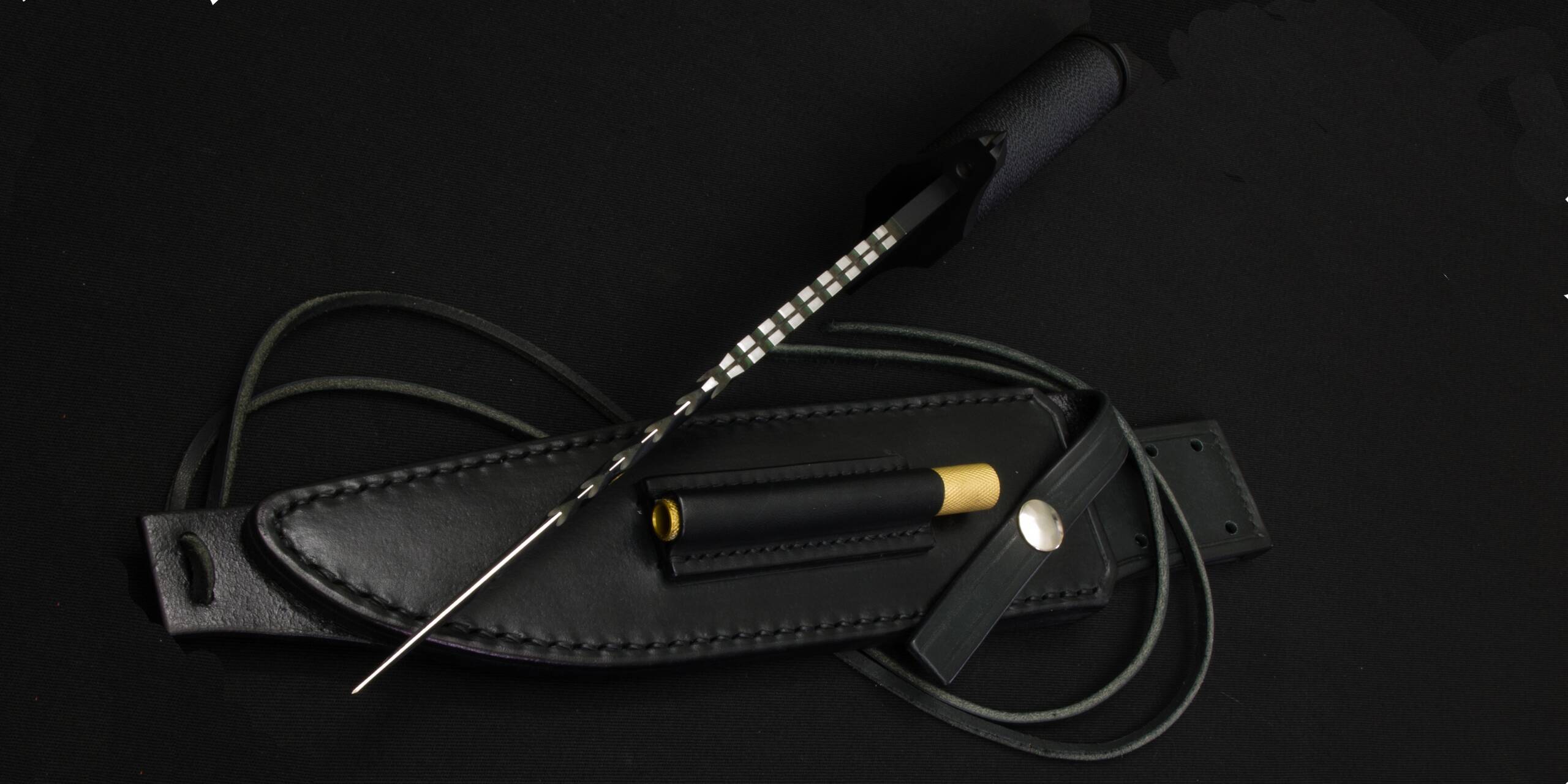 The leather sheath of the Mission with the cord wound round it and the brass-capped sharpener in its pocket
