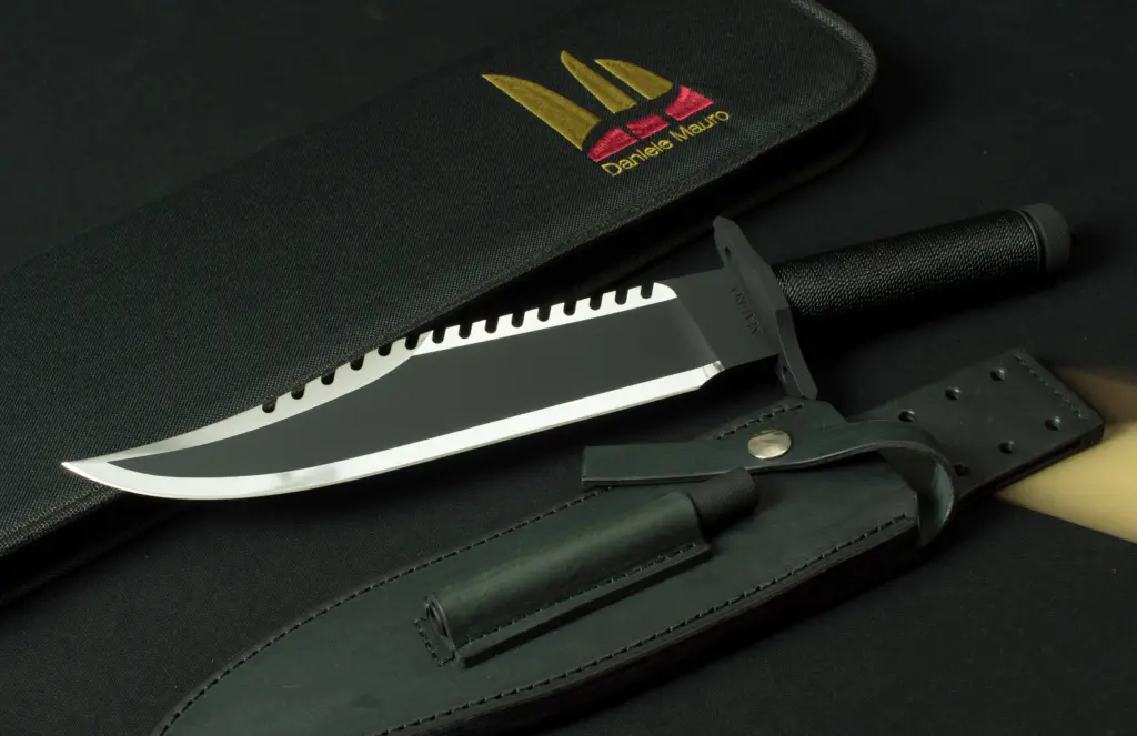 The Mission beside the black leather sheath with its sharpener pocket